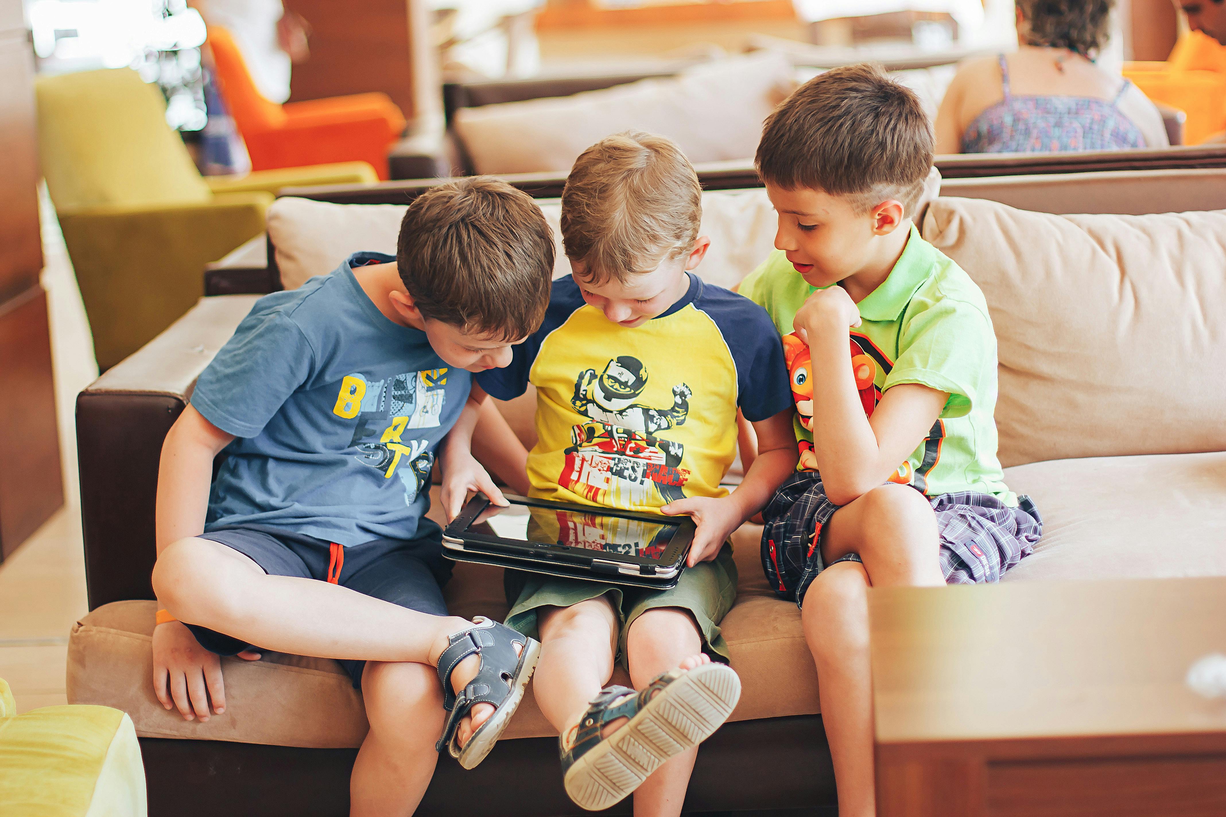 3 boys all playing on an ipad